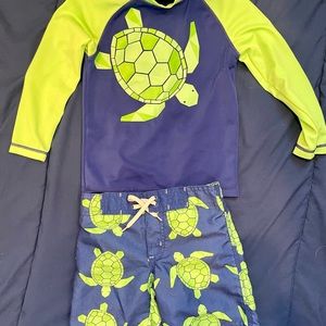 Four 18-24 month to 2T swim trunks and 3 rash guards